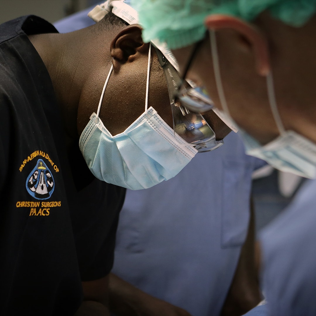 African surgeon wearing a surgical mask.